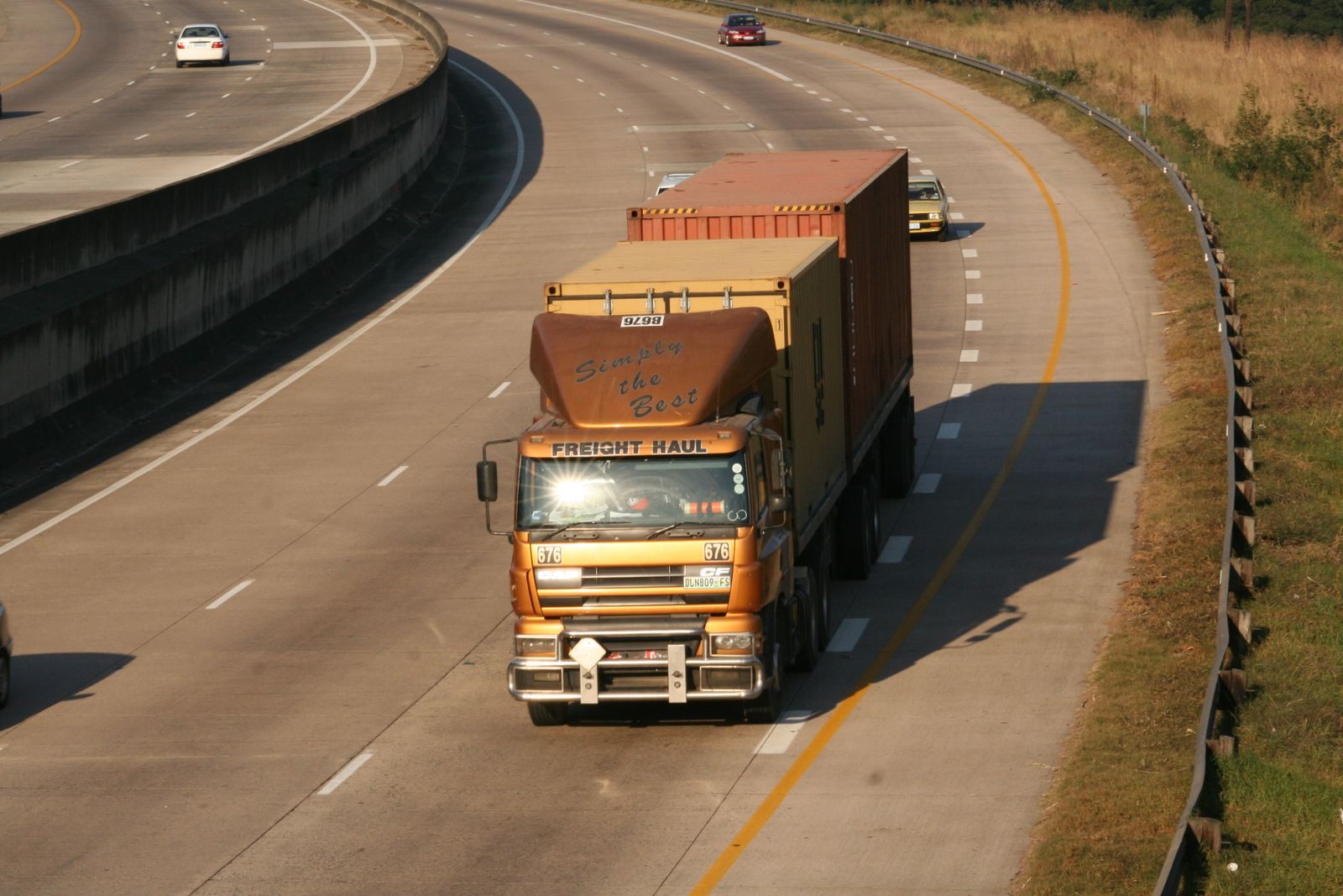 Cargo truck navigating a highway, aerial view on Dolphin Coast, South Africa
